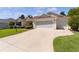 Single-story house with a two-car garage and well-maintained landscaping at 546 Foxfield Path, The Villages, FL 32162