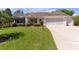 Attractive single-story home with a two-car garage and well-manicured lawn at 546 Foxfield Path, The Villages, FL 32162