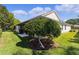 House exterior with lush landscaping at 546 Foxfield Path, The Villages, FL 32162