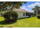 Well-maintained house exterior with side yard and landscaping at 546 Foxfield Path, The Villages, FL 32162