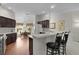 Bright eat-in kitchen with dark wood cabinets, breakfast bar, and stainless steel appliances at 546 Foxfield Path, The Villages, FL 32162