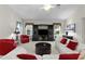 Bright living room with a plush seating area, a dark entertainment center, and natural light from large windows at 546 Foxfield Path, The Villages, FL 32162