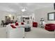 Expansive living area with plush seating, an open-concept design, and a glimpse of the adjacent kitchen area at 546 Foxfield Path, The Villages, FL 32162