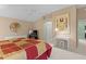 Spacious main bedroom features a ceiling fan, ensuite bathroom, and comfortable bed at 546 Foxfield Path, The Villages, FL 32162