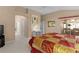 Spacious main bedroom features a ceiling fan, ensuite bathroom, and comfortable bed at 546 Foxfield Path, The Villages, FL 32162