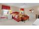 Spacious main bedroom features a ceiling fan, ensuite bathroom, and comfortable bed at 546 Foxfield Path, The Villages, FL 32162