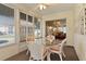 Cozy sunroom with a glass table and wicker chairs, perfect for entertaining at 546 Foxfield Path, The Villages, FL 32162