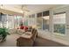 Relaxing sunroom with neutral color scheme, ceiling fan and many windows at 546 Foxfield Path, The Villages, FL 32162