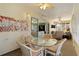 This sunroom has great natural light, art, and access to other rooms at 546 Foxfield Path, The Villages, FL 32162