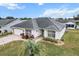 Single-story house with a gray roof and a spacious backyard at 603 San Pedro Dr, Lady Lake, FL 32159