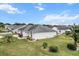 View of the house from the back, showing the backyard and AC unit at 603 San Pedro Dr, Lady Lake, FL 32159