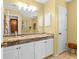 Well-lit bathroom with double sink vanity, granite countertop, and tile flooring at 603 San Pedro Dr, Lady Lake, FL 32159