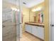 Bathroom featuring a glass shower, tile floors, and vanity with double sinks at 603 San Pedro Dr, Lady Lake, FL 32159