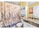 Cozy bathroom features floral curtain and vanity with granite countertop at 603 San Pedro Dr, Lady Lake, FL 32159