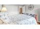Comfortable bedroom with spacious closet, compass wall decor and patterned quilt at 603 San Pedro Dr, Lady Lake, FL 32159
