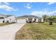 One-story home with attached garage and landscaped front yard at 603 San Pedro Dr, Lady Lake, FL 32159