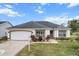 Attractive single-story home with a two-car garage and well-manicured lawn at 603 San Pedro Dr, Lady Lake, FL 32159