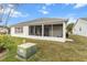 Home exterior showcasing a screened porch and well-maintained lawn at 603 San Pedro Dr, Lady Lake, FL 32159