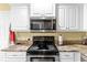 Kitchen with stainless steel appliances and granite countertops at 603 San Pedro Dr, Lady Lake, FL 32159