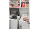 Bright laundry room features a washer, dryer, and storage shelves at 603 San Pedro Dr, Lady Lake, FL 32159