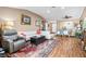 Living room features hardwood floors, neutral decor and a view of the dining area at 603 San Pedro Dr, Lady Lake, FL 32159