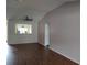 Spacious living room with wood floors, ceiling fan, and open view to the kitchen at 603 San Pedro Dr, Lady Lake, FL 32159