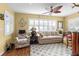Inviting living room featuring plantation shutters, hardwood floors, and a cozy seating area at 603 San Pedro Dr, Lady Lake, FL 32159