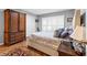 Bedroom showcasing natural light, a large bed, wood floors and ample closet space at 603 San Pedro Dr, Lady Lake, FL 32159