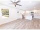Open floor plan with sleek white cabinets, an island, and wood-look flooring under recessed lighting and a fan at Lot 17 Indian Estates Cr 423, Lake Panasoffkee, FL 33538