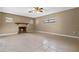 Living room with fireplace and sliding glass doors to the pool area at 1033 Shore Acres Rd, Mount Dora, FL 32757