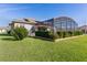 Spacious backyard with screened enclosure and lush landscaping at 11038 Se 170Th Lane Rd, Summerfield, FL 34491