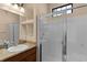 Clean bathroom with shower, vanity, and recessed shelving at 11038 Se 170Th Lane Rd, Summerfield, FL 34491