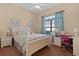 Bright bedroom featuring a king-size bed and a workspace at 11038 Se 170Th Lane Rd, Summerfield, FL 34491