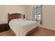 King-size bed in a well-lit bedroom with carpet flooring at 11038 Se 170Th Lane Rd, Summerfield, FL 34491