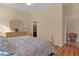Bright bedroom with a king-size bed and wood flooring at 11038 Se 170Th Lane Rd, Summerfield, FL 34491