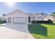 Charming one-story house with a two-car garage, and lush green lawn at 11038 Se 170Th Lane Rd, Summerfield, FL 34491