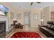 Living room with fireplace, leather furniture, and views of the foyer and kitchen at 11038 Se 170Th Lane Rd, Summerfield, FL 34491