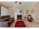 Comfortable living room with fireplace, leather furniture and large TV at 11038 Se 170Th Lane Rd, Summerfield, FL 34491