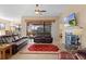 Relaxing living room with fireplace, leather furniture, and access to patio at 11038 Se 170Th Lane Rd, Summerfield, FL 34491