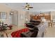 Open concept living room with kitchen access, leather furniture, and views of the foyer at 11038 Se 170Th Lane Rd, Summerfield, FL 34491