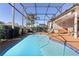 Inviting kidney-shaped pool with screened enclosure at 11038 Se 170Th Lane Rd, Summerfield, FL 34491