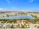 Aerial view of waterfront property with homes and lake at 1559 Nassau Cir, Tavares, FL 32778