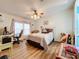 Bedroom with hardwood floors, a bed, and a workspace at 1559 Nassau Cir, Tavares, FL 32778