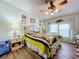 Bright bedroom with ceiling fan, hardwood floors, and a comfortable bed at 1559 Nassau Cir, Tavares, FL 32778