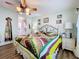 Spacious bedroom with ceiling fan, hardwood floors, and access to bathroom at 1559 Nassau Cir, Tavares, FL 32778