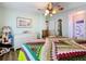 Well-lit bedroom with hardwood floors, dresser, and a large bed at 1559 Nassau Cir, Tavares, FL 32778