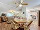 Open dining area with wood floors and view to the living room at 1559 Nassau Cir, Tavares, FL 32778