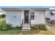 Exterior view of home with steps and landscaping at 1559 Nassau Cir, Tavares, FL 32778