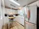Bright kitchen with stainless steel appliances and wood-look flooring at 1559 Nassau Cir, Tavares, FL 32778