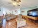 Spacious living area with large TV and access to a sunroom at 1559 Nassau Cir, Tavares, FL 32778